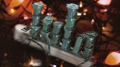 Power bar overloaded with plugs for Christmas lights
