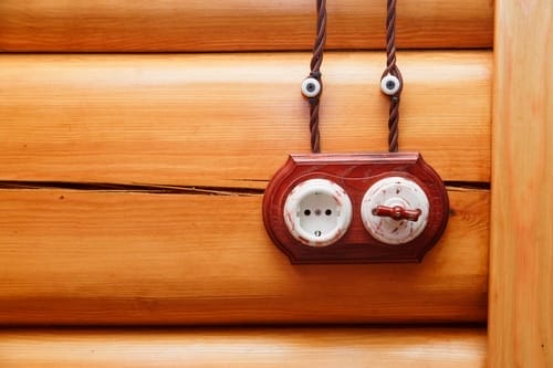 Old knob and tube light switch on cedar wall