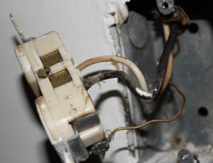 Inside of an old outlet with older wiring