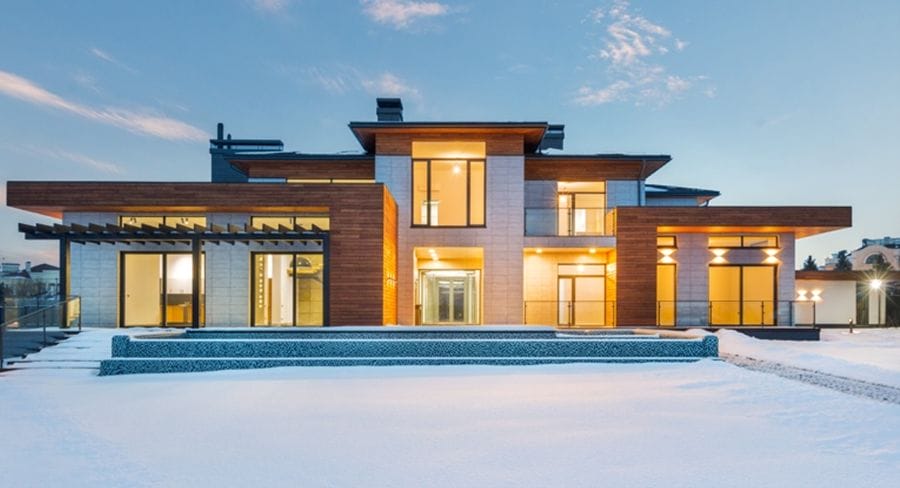 A house with a large yard in the snow